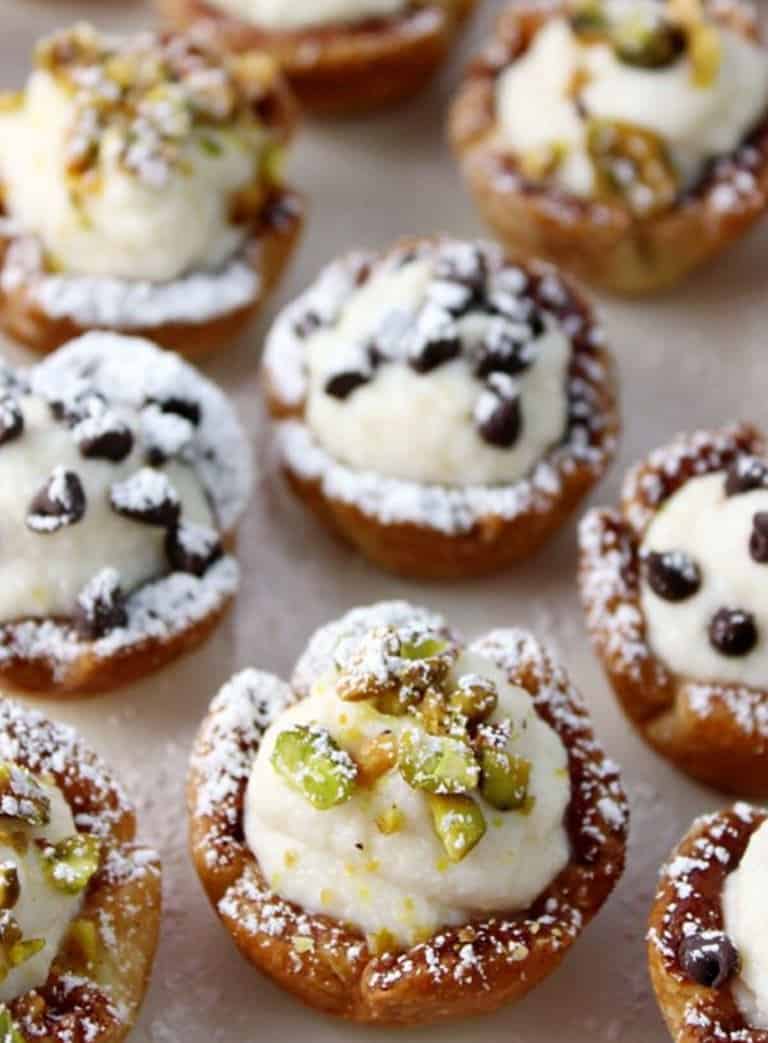 Canoli cups with cream, pistachios and chocolate chips. 