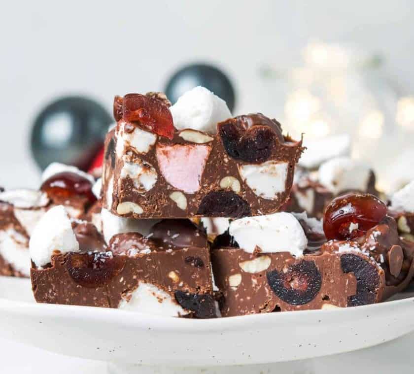 Dessert bars with cherries and marshmellows on a tray.