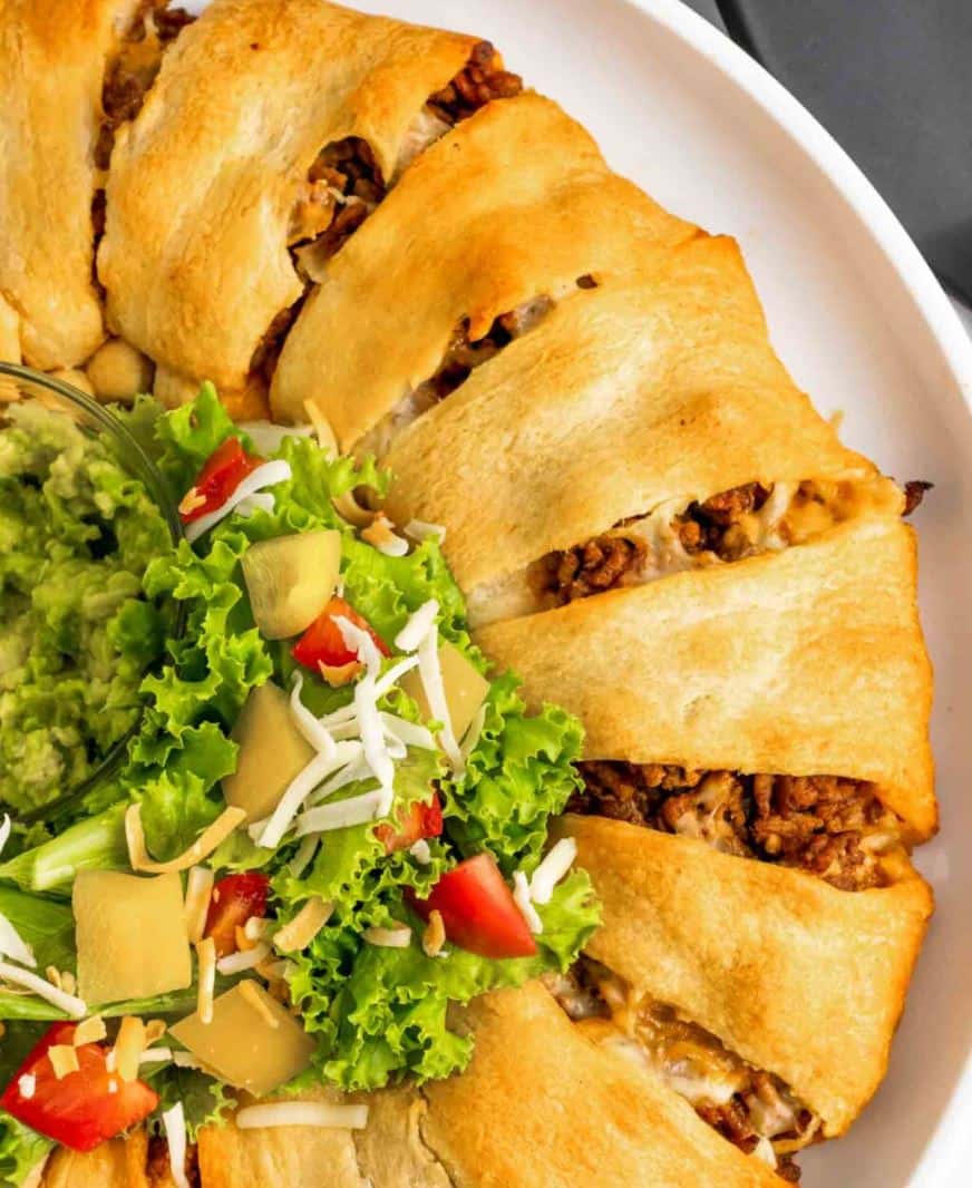 Taco pull apart appetizer with vegetables and guacamole.