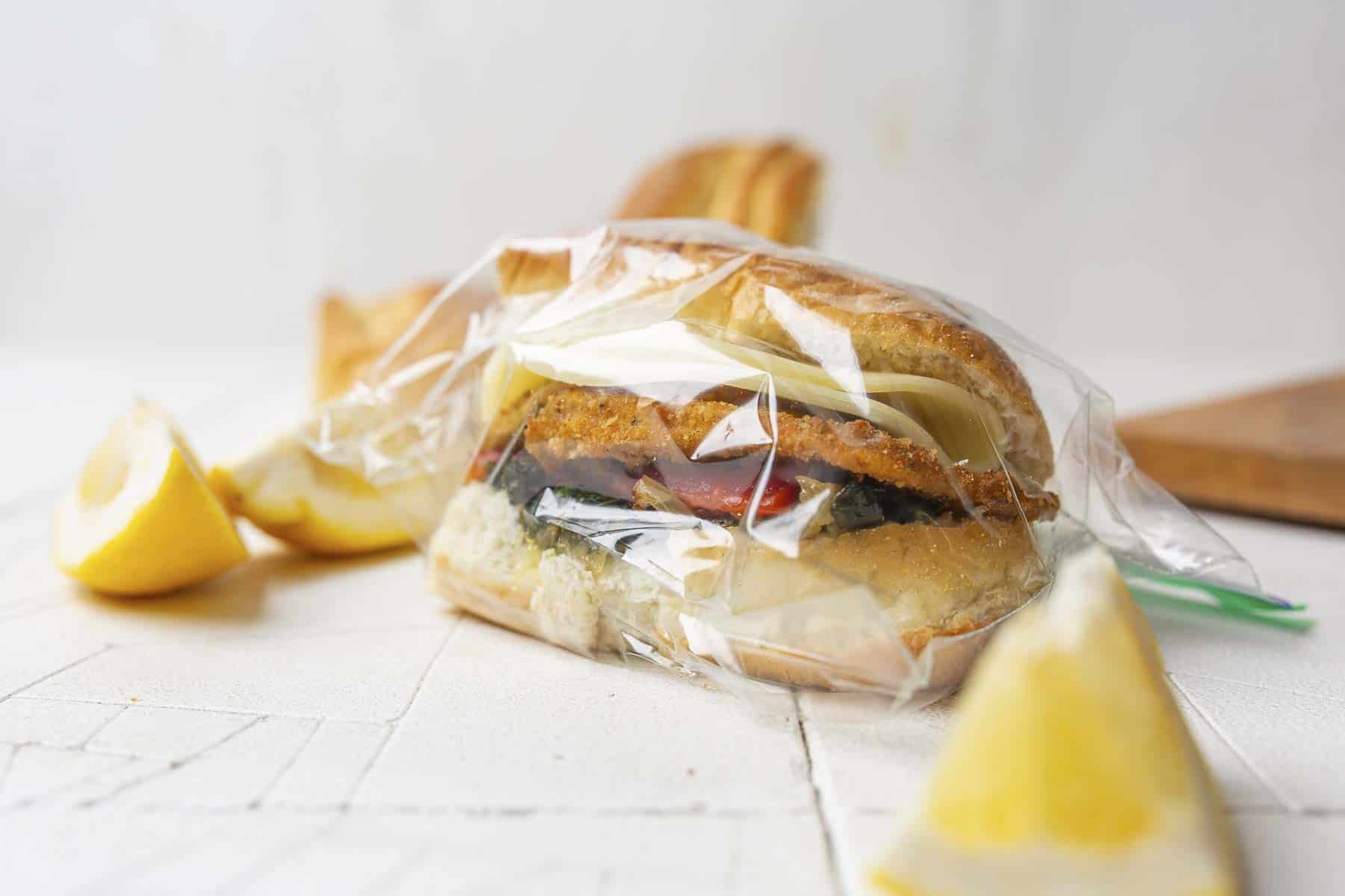 Vegetarian eggplant sandwich wrapped in a plastic baggie.