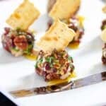 Mini cream cheese balls with pecans, craisins and herbs.