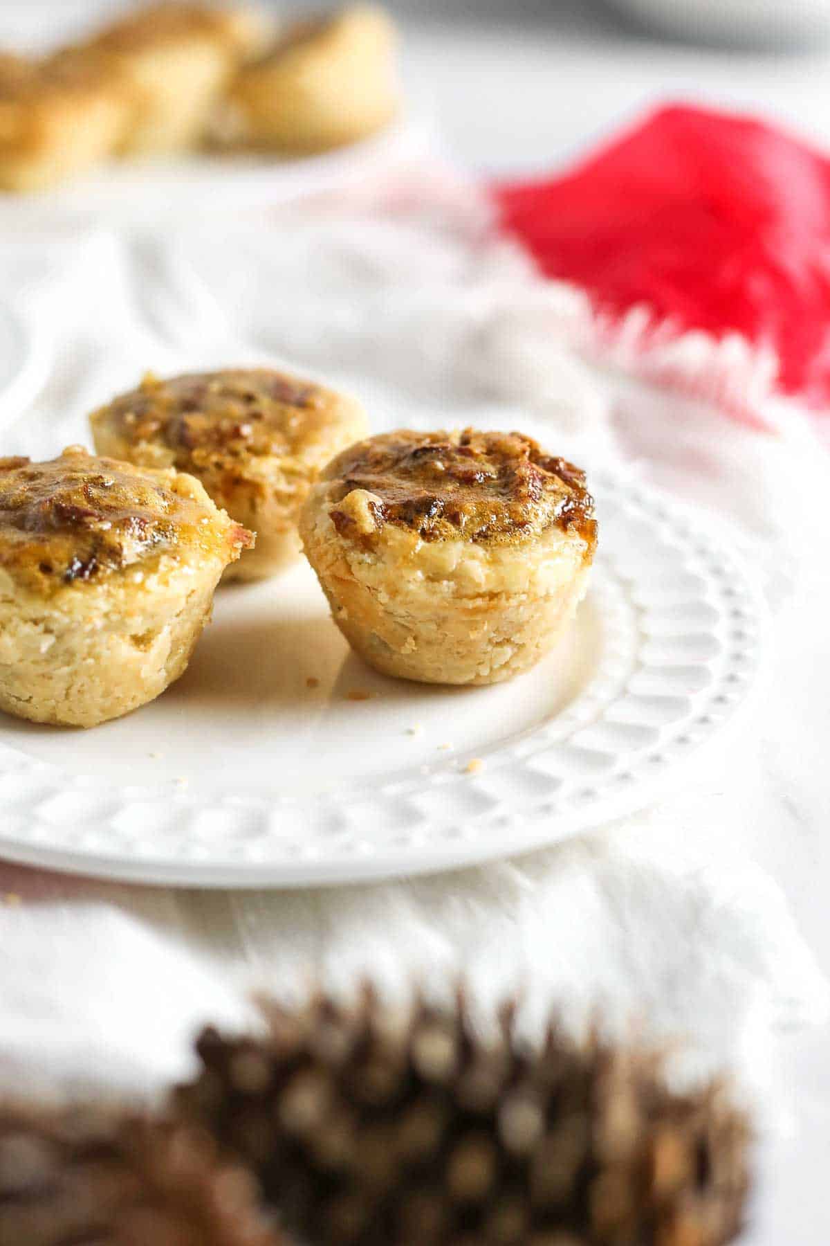 Pecan tassie nut cups on a plate.