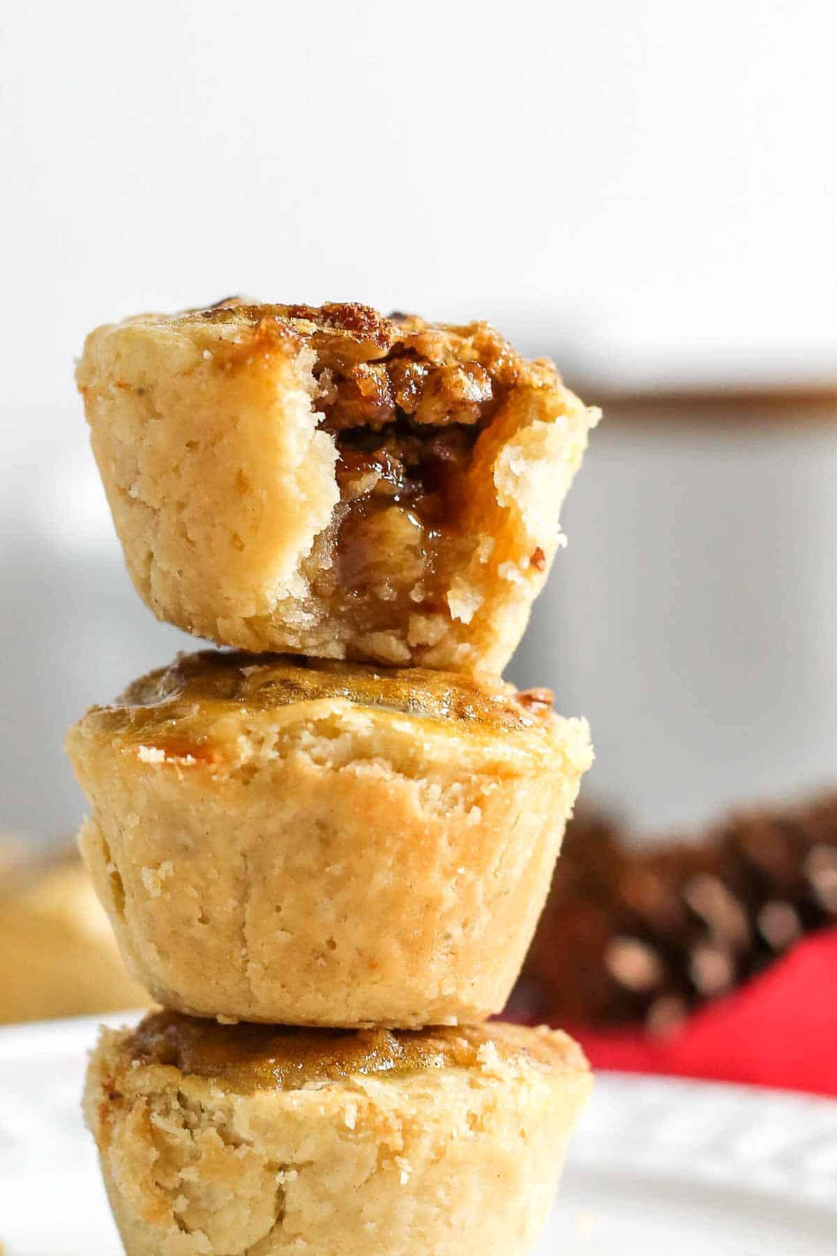 Pecan tassie nut cups stacked on top of each other.