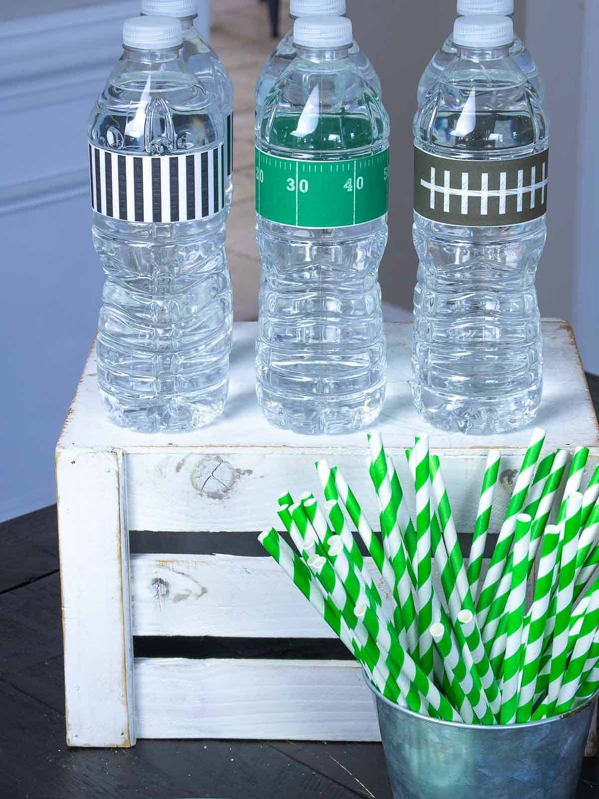 Water bottles with football labels on table.