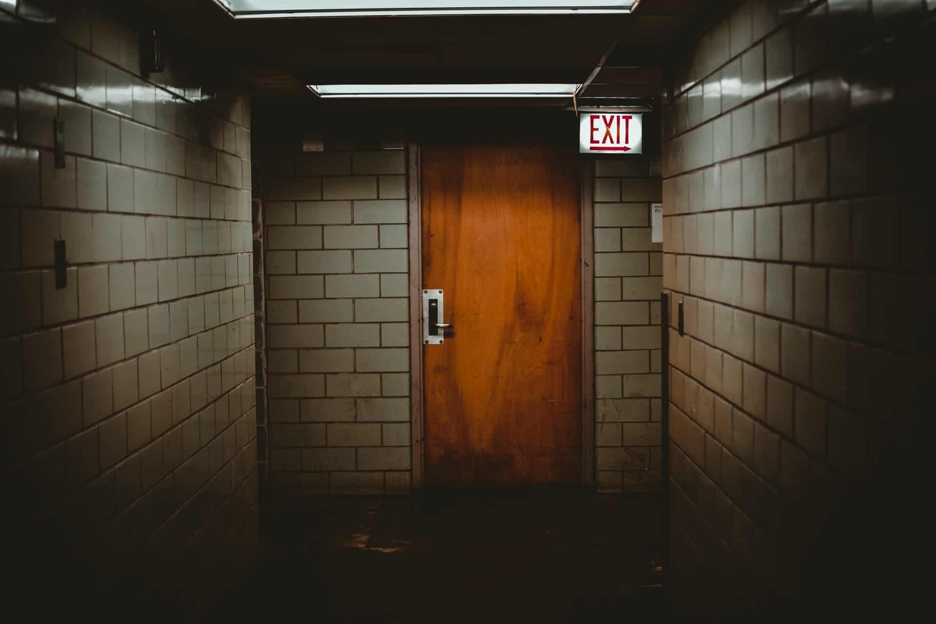 Mystery exit door in a dark room.