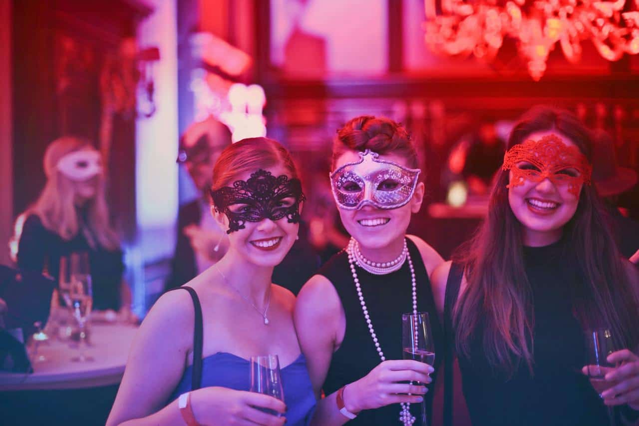 Three women wearing masks.