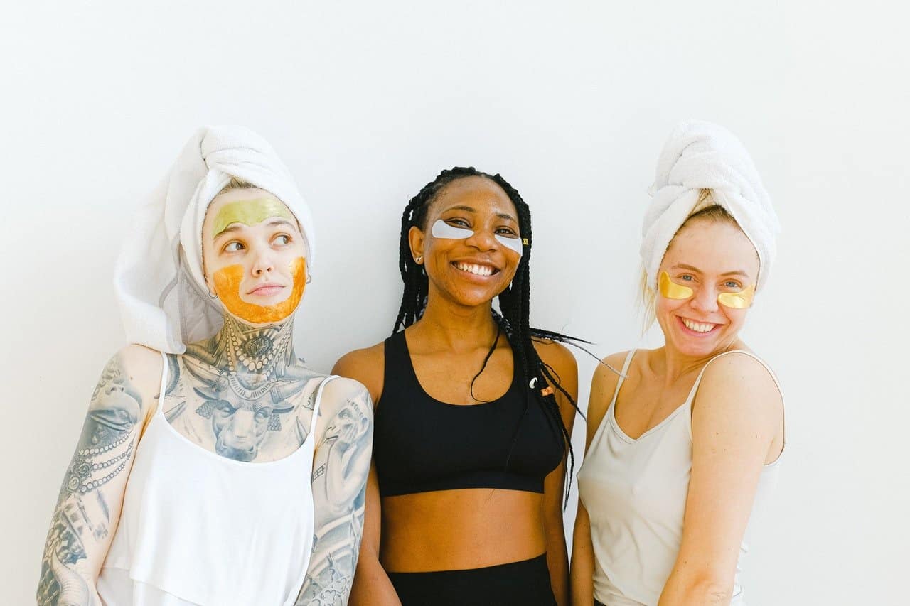 Three women with facial masks.