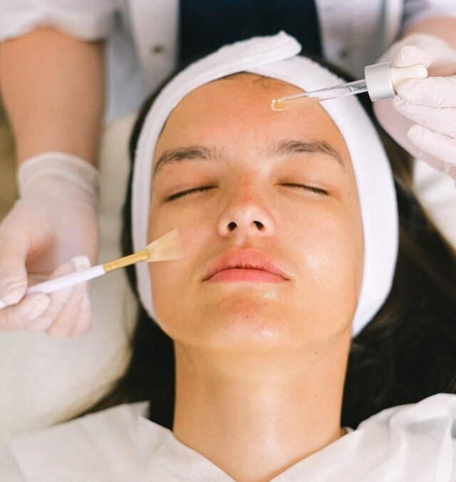 Young girl receiving facial.