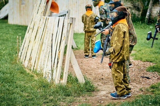 Kids playing paintball.