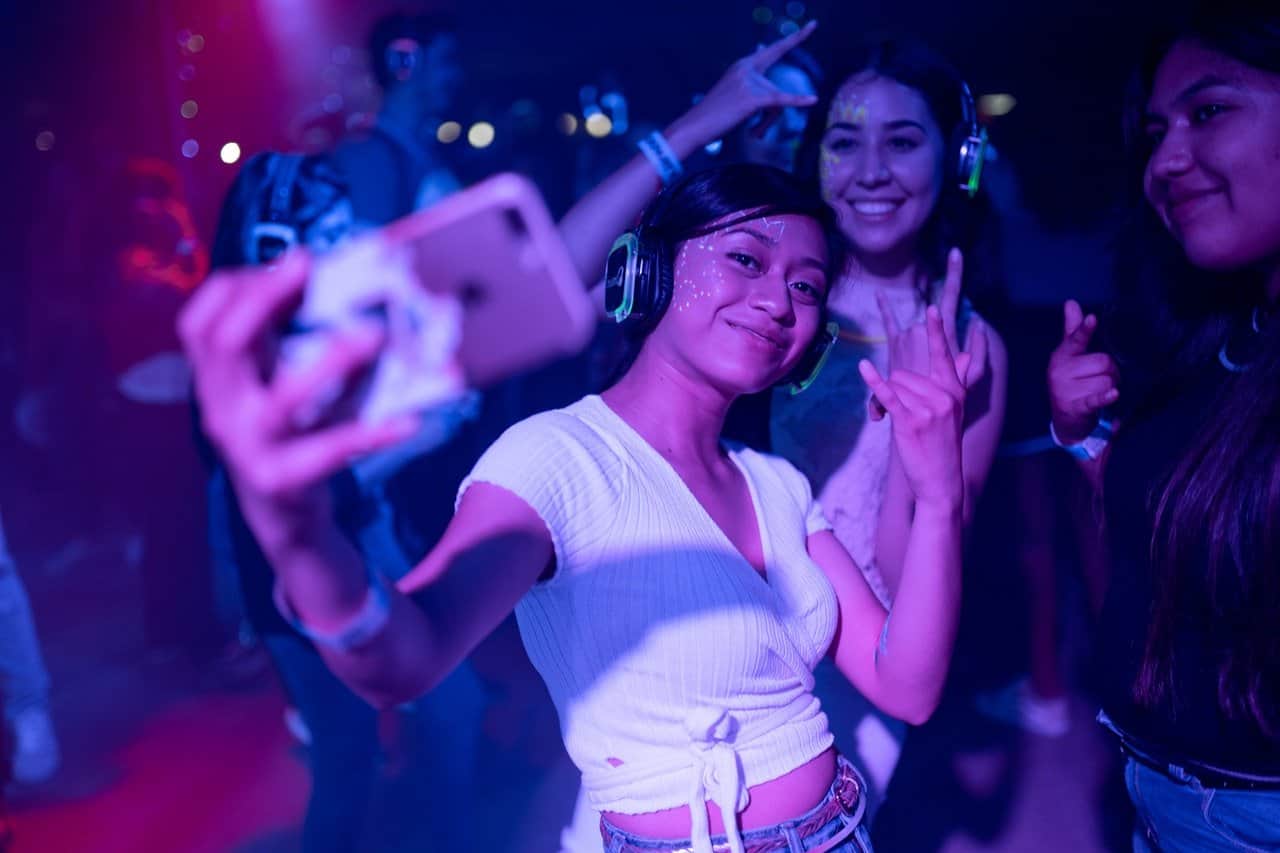 Woman king a selfie at a dance party.