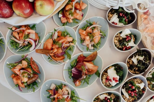 Bowls of food on buffet table,.