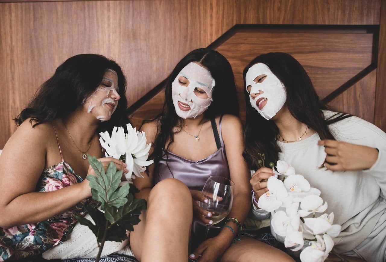 Three women sitting with spa facials.