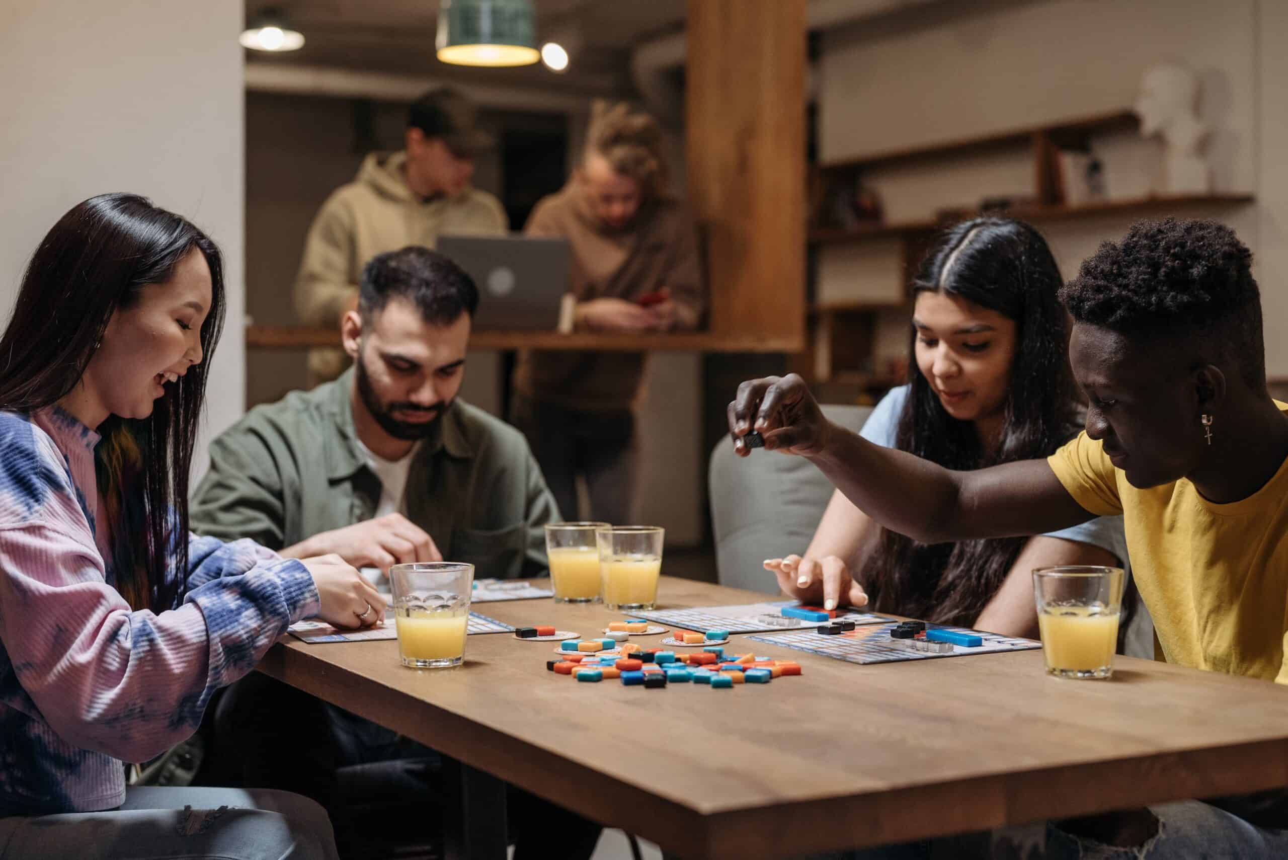 A group of friends playing board games makes great housewarming party ideas.