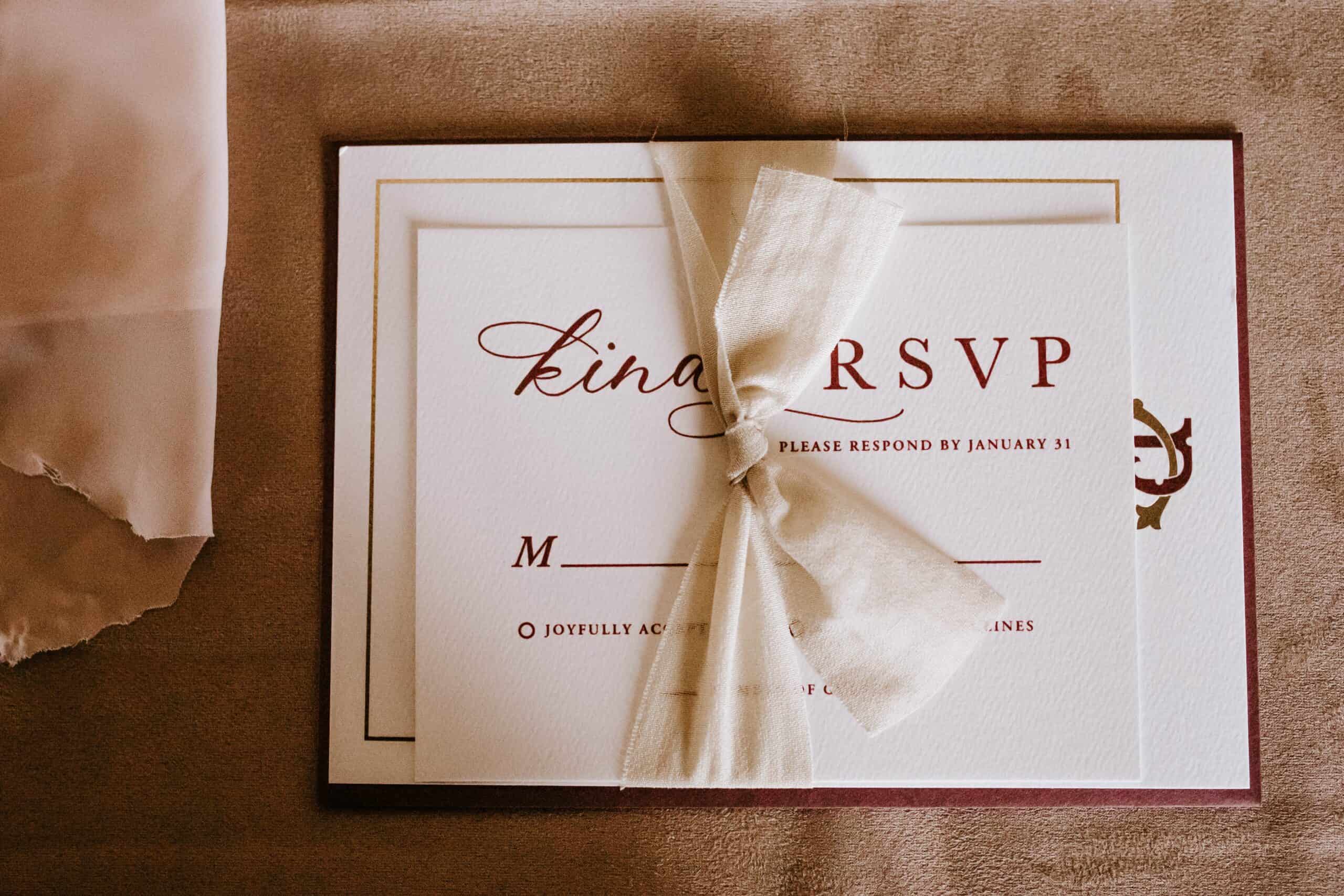 RSVP card tied with a bow.