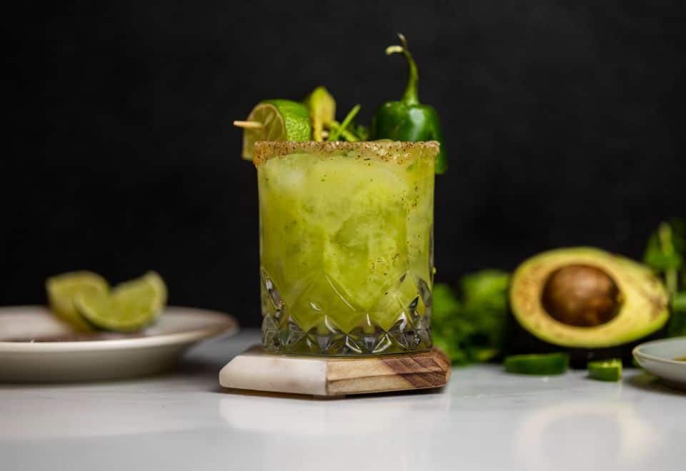 Avocado margarita on table with jalapeno.