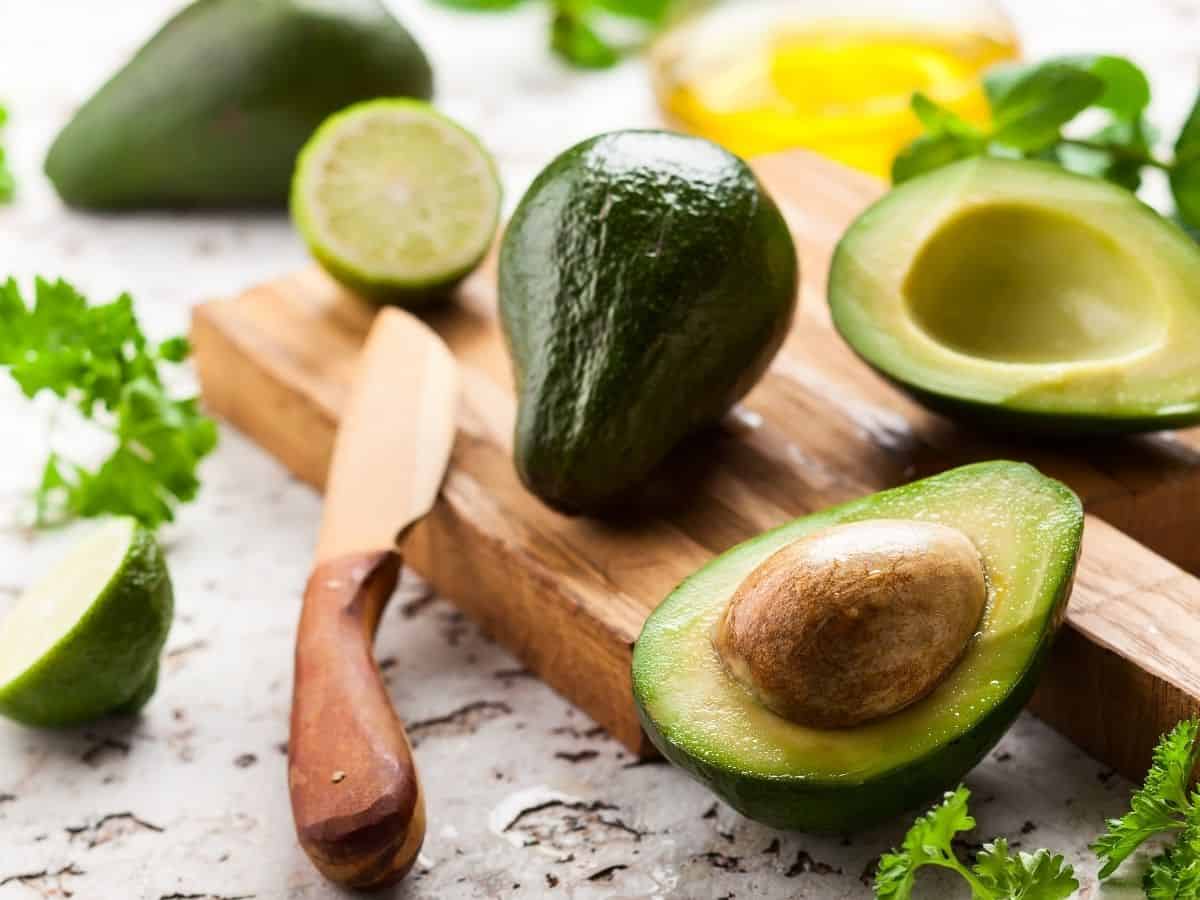 Avocados on table cut in half.