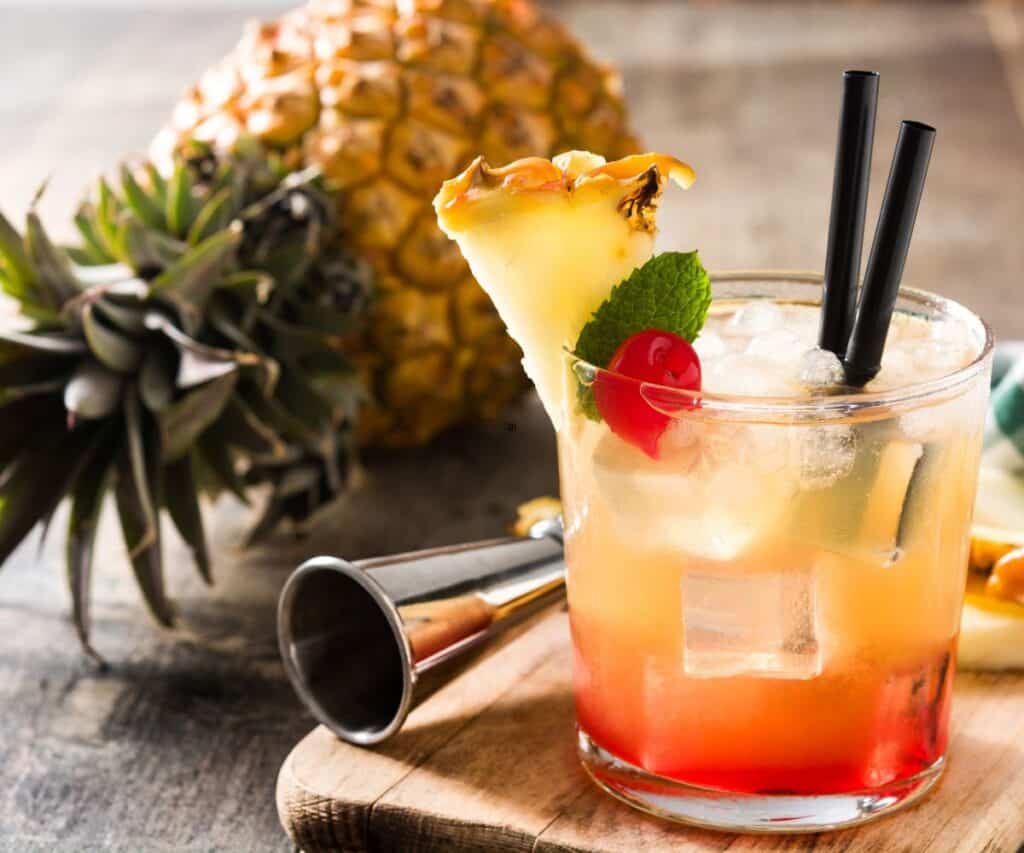 Mai tai cocktail with pineapple and cherry.
