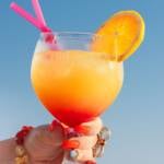 Sex on the beach fruity cocktail with straw.
