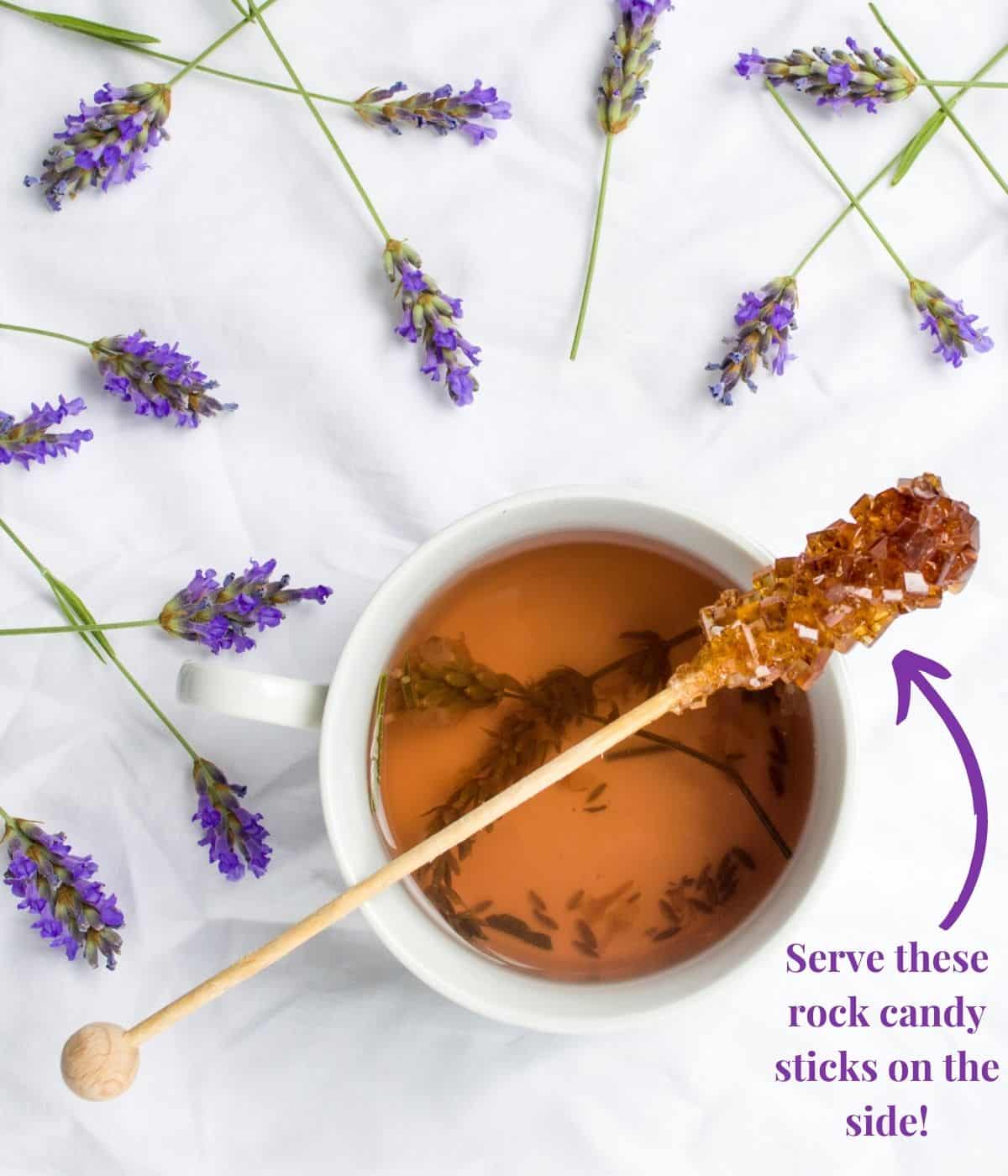 Tea cup with sugar crystal stick.