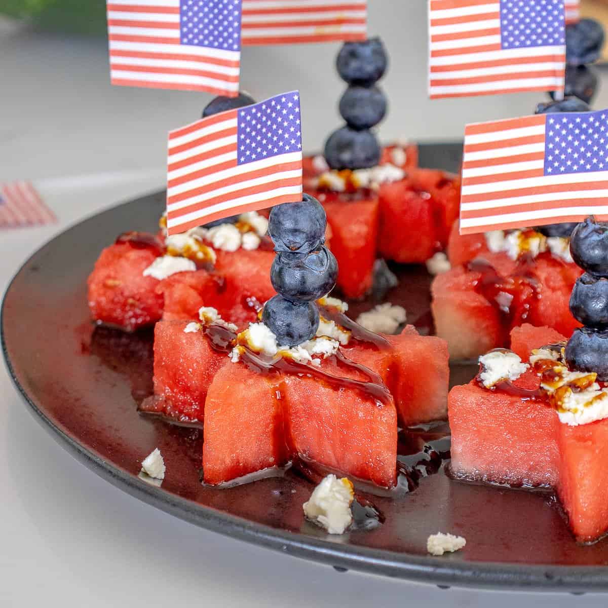 Watermelon stars with feta cheese and blueberries and American flag toothpick.