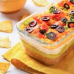 7 layer Mexican taco dip in a long glass dish.
