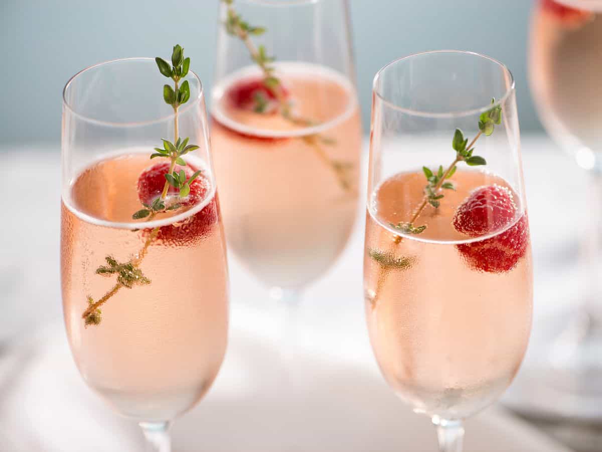 Champagne glass with champagne and berries.