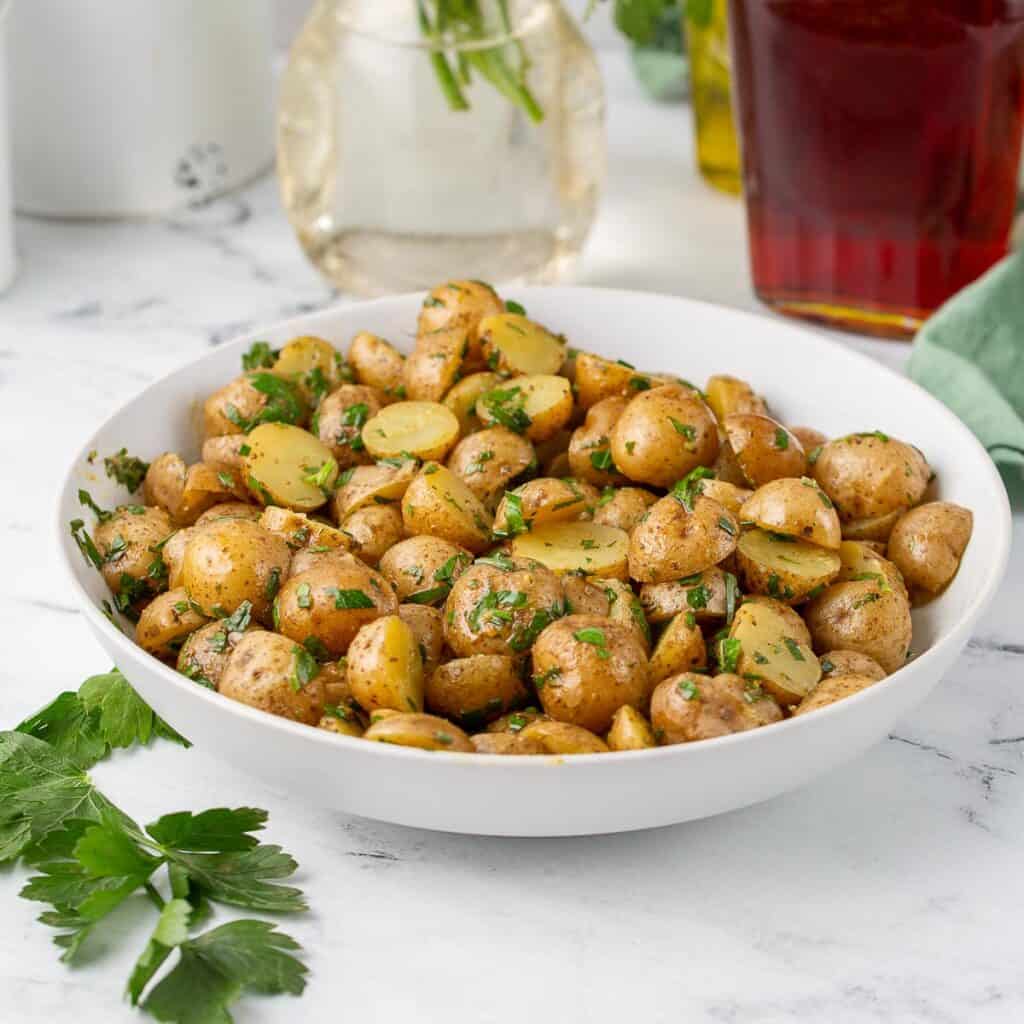 Herbed potato salad without mayonaisse in a bowl.