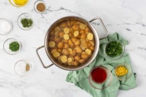 Halved potatoes in a pot.