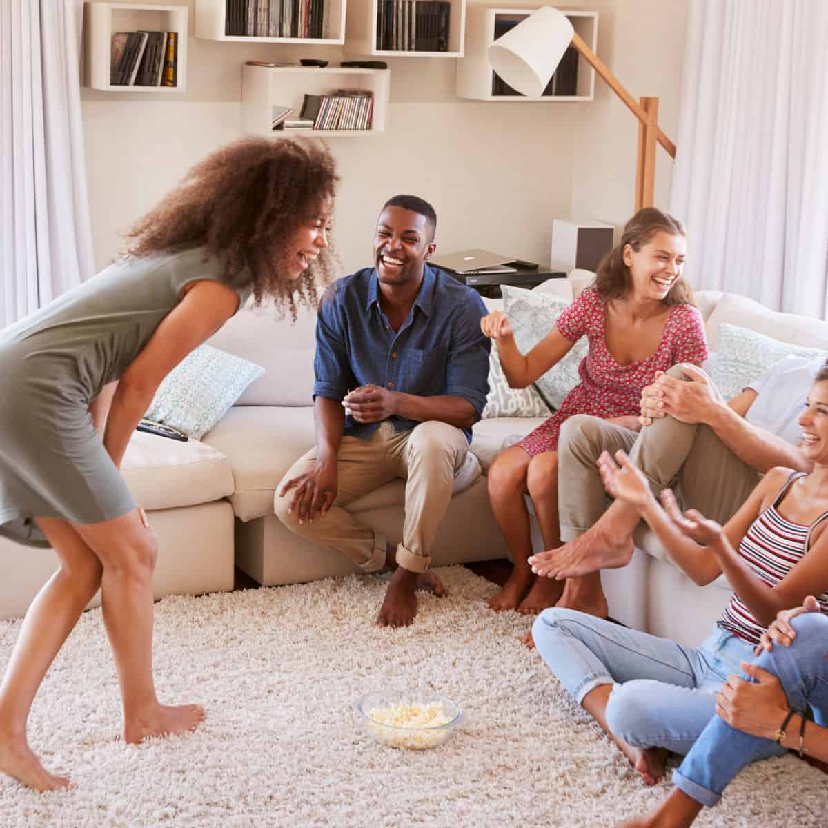 Adults playing a game at a party.