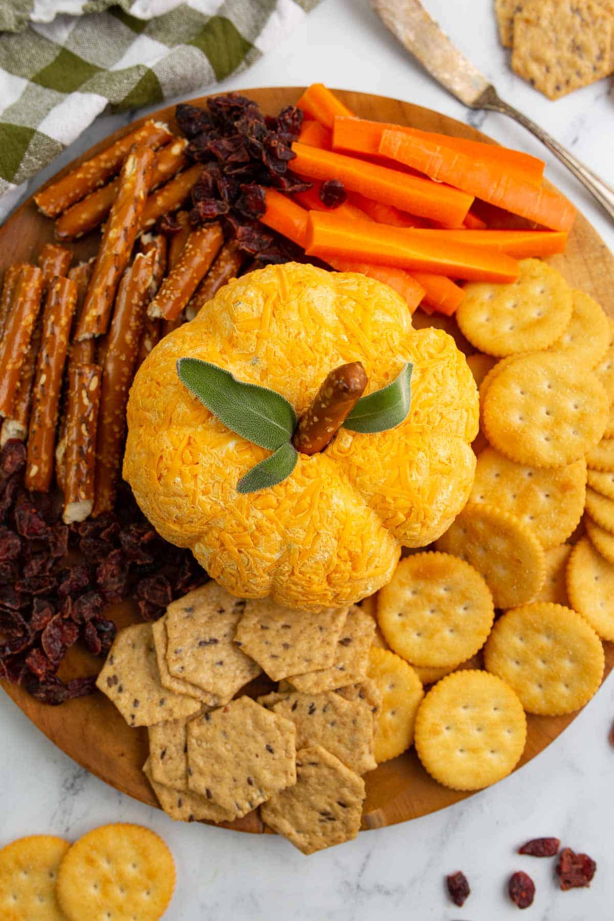 Overhead shot of pumpkin cheese ball with dippers.