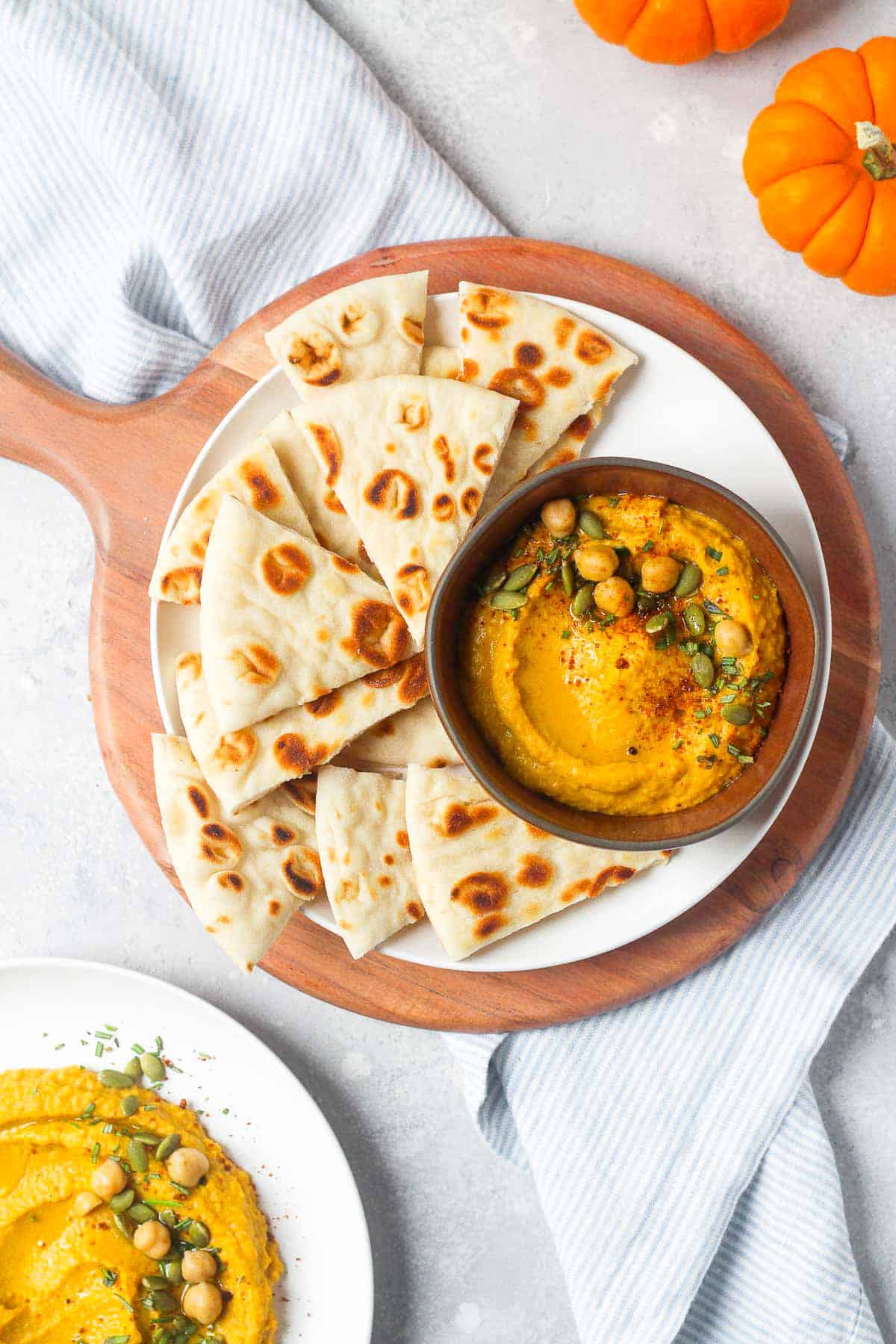 Pumpkin hummus on table with pita bread.