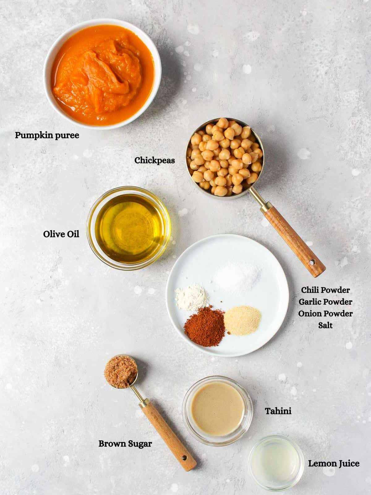 Ingredients to make pumpkin hummus on table.