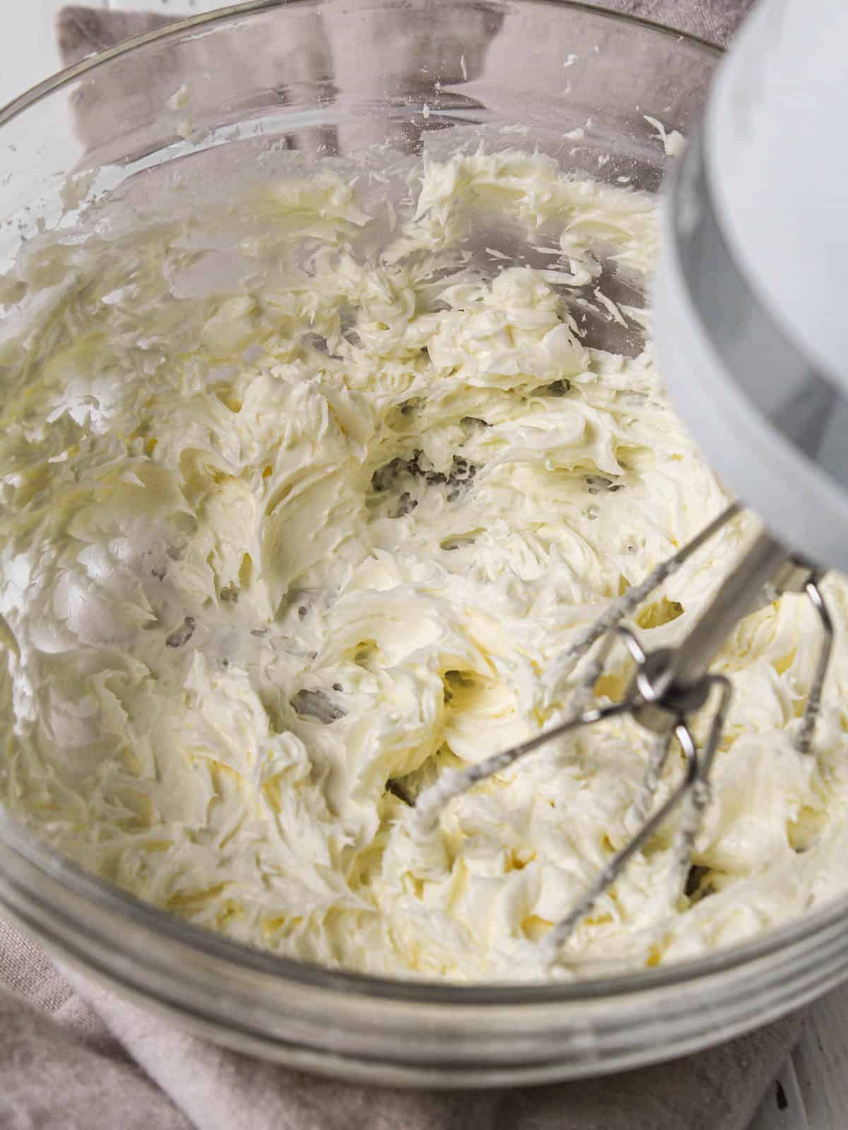 Whipping up brandy butter in bowl with mixer.