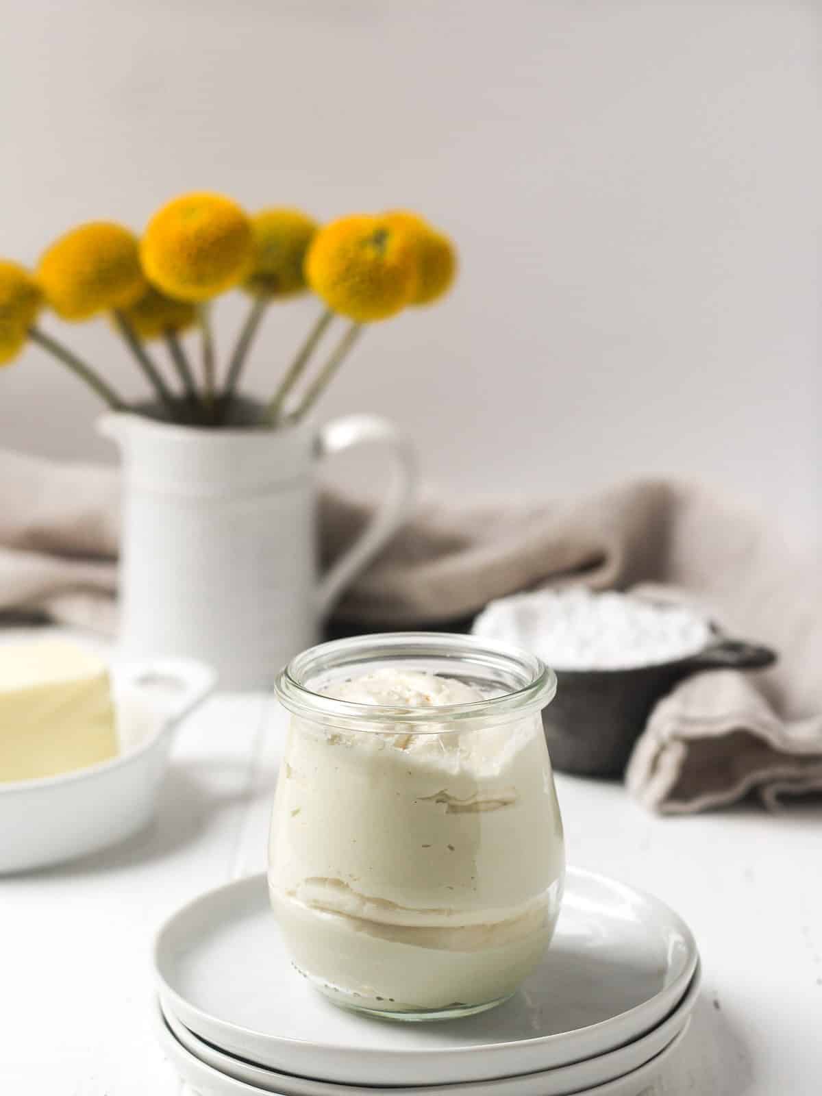 Brandy butter in a glass on table.