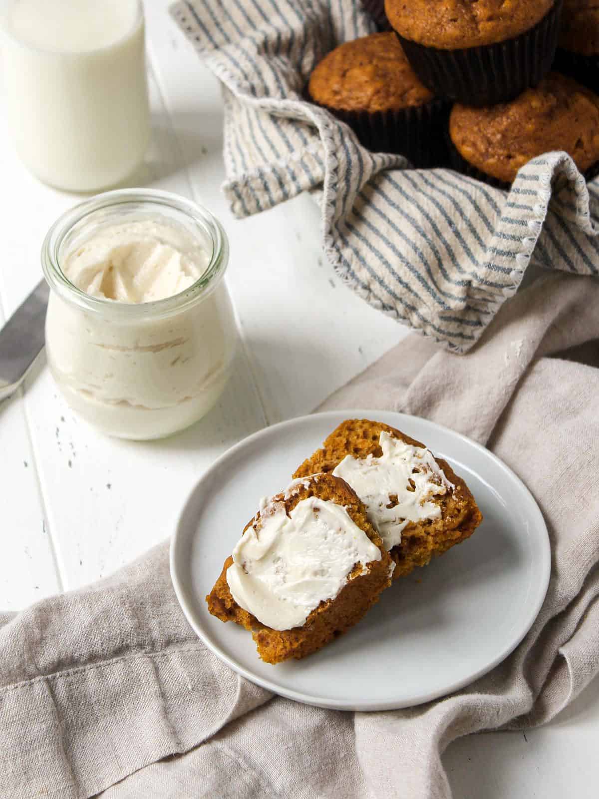 Brandy butter on the table spread onto a loaf of bread.