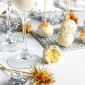 New years eve cake balls on table with milk flutes and tassels.