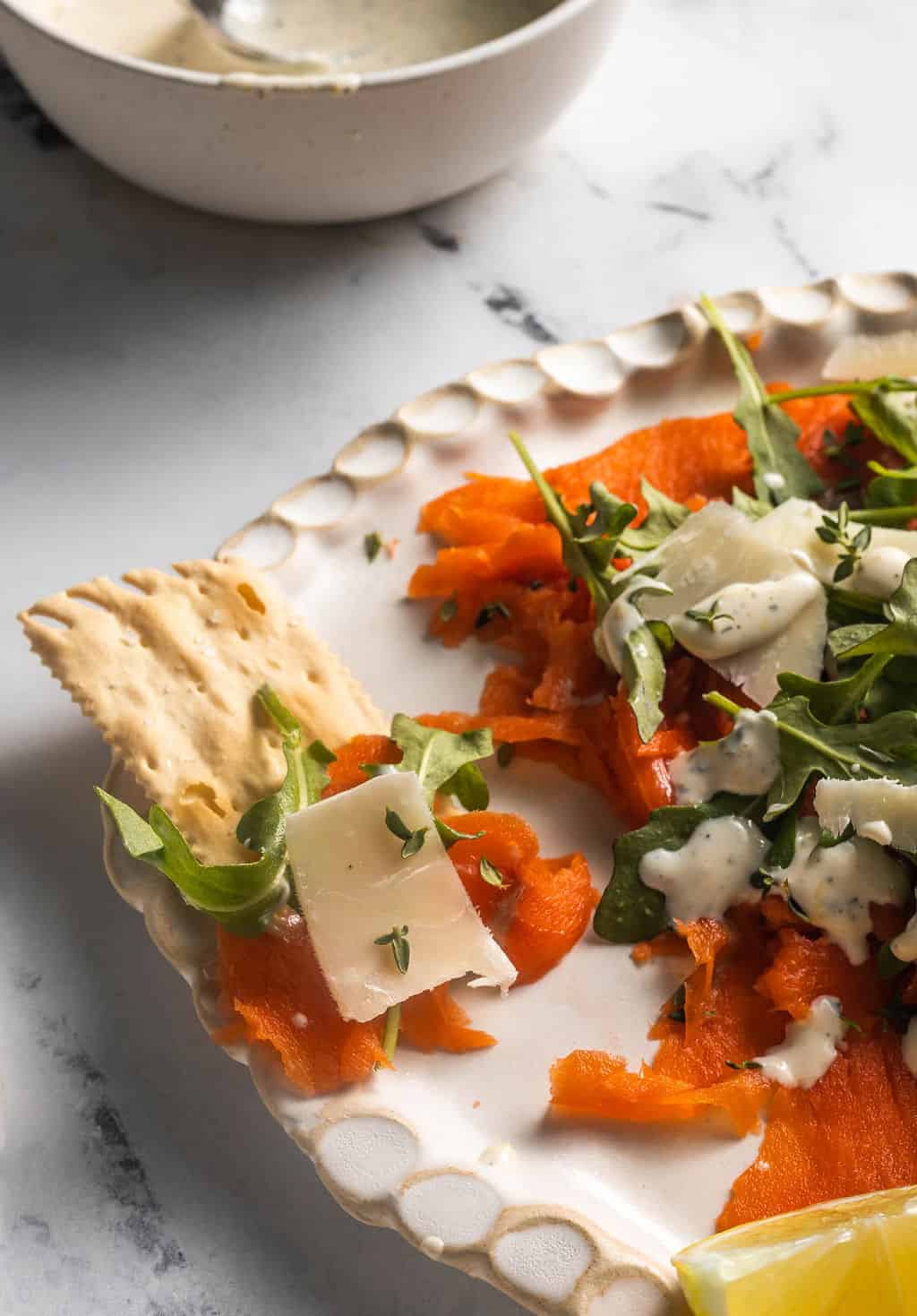 Smoked salmon carpaccio on crackers.