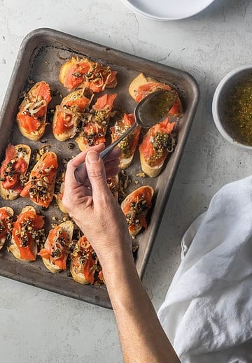 Putting toppings to crostini.