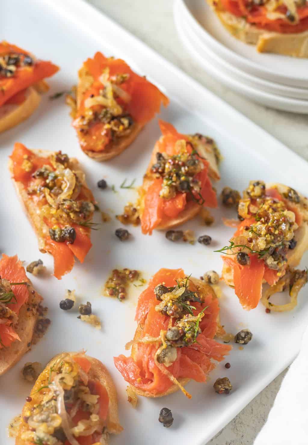 Smoked salmon appetizer on white plate.