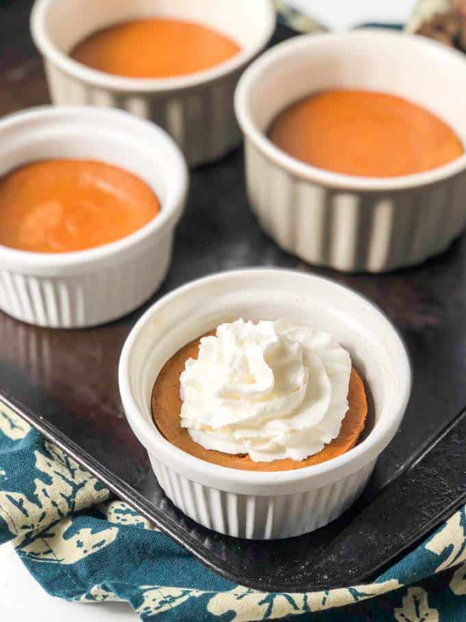 Keto pumpkin pie dessert cup topped with whipped cream.