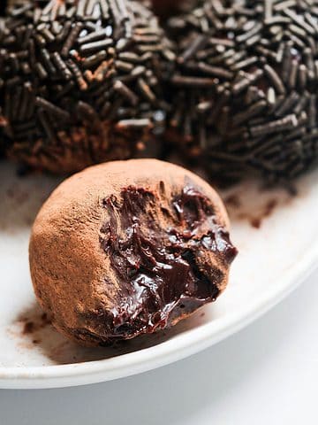 Chocolate truffles with condensed milk on table.