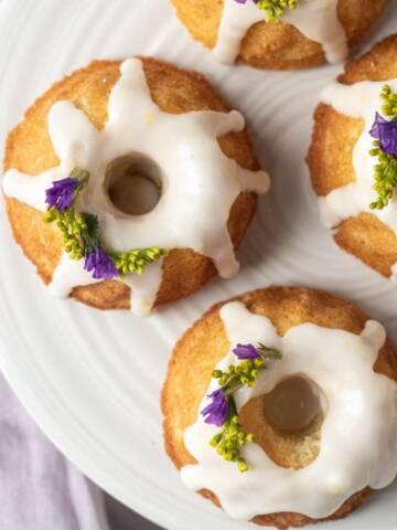 Mini bundt cakes overview with lemon icing and flowers.