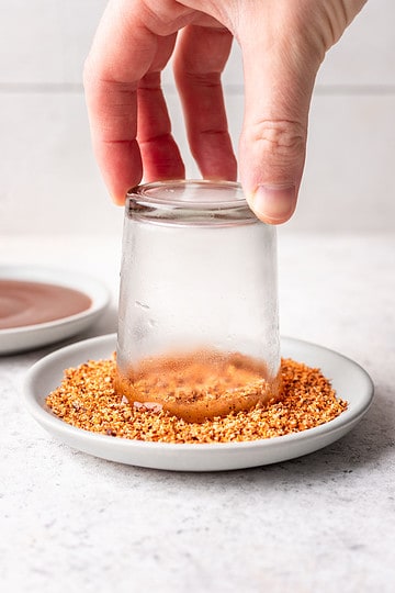 Shot glass rim dipped into seasoning.