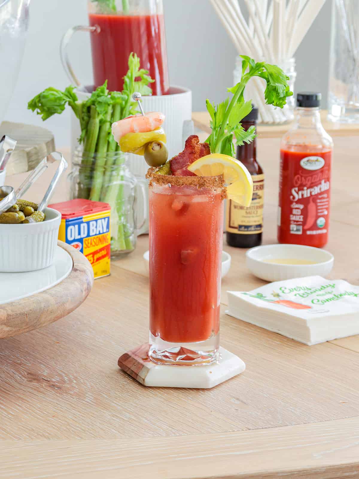 Bloody mary with fancy garnish ontable.