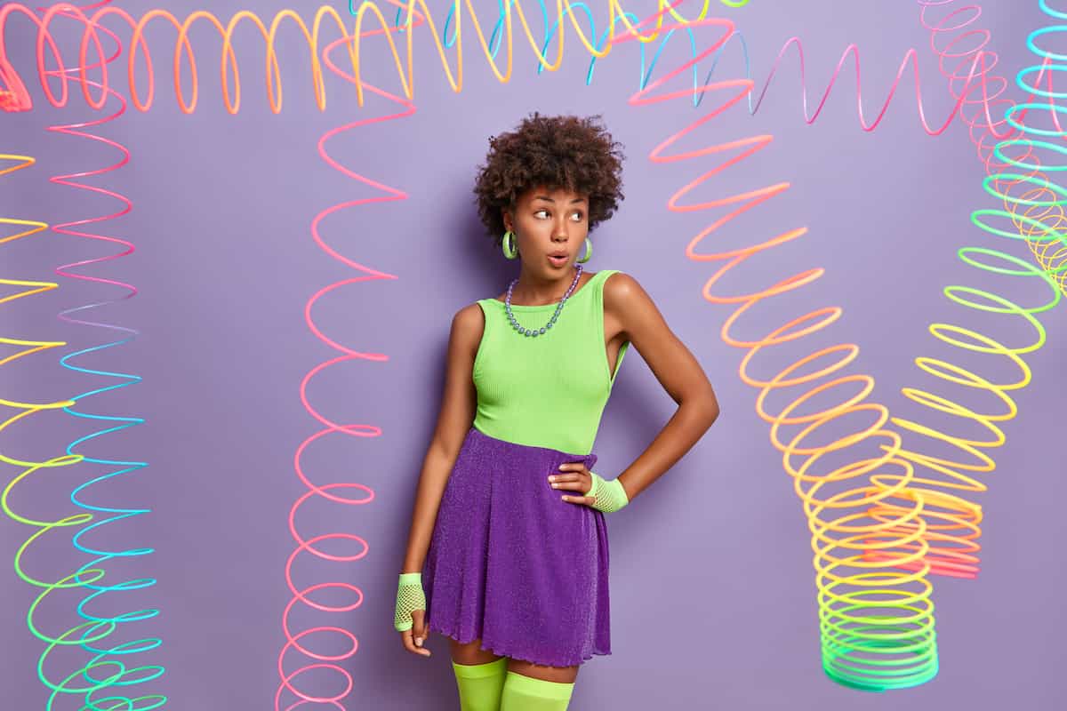 Lumo green and purple outfit with hoop earings.