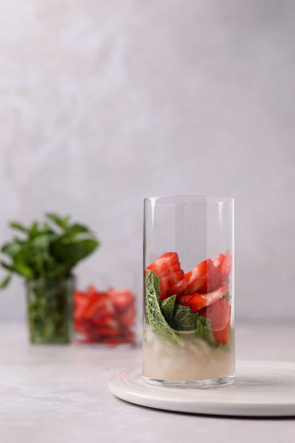 Strawberries, mint and lime juice in a glass.