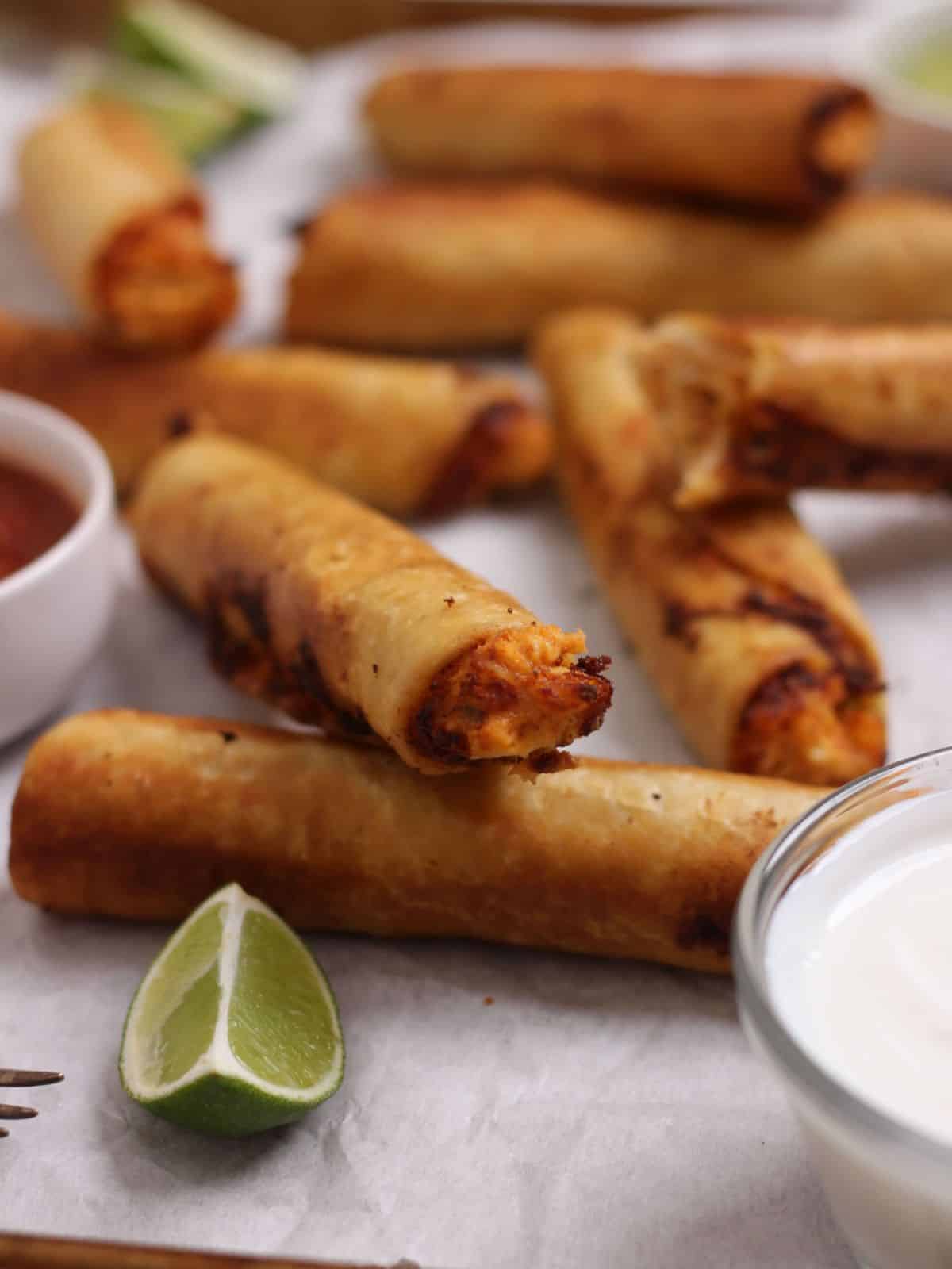 Chicken flautas fried on sheet pan.