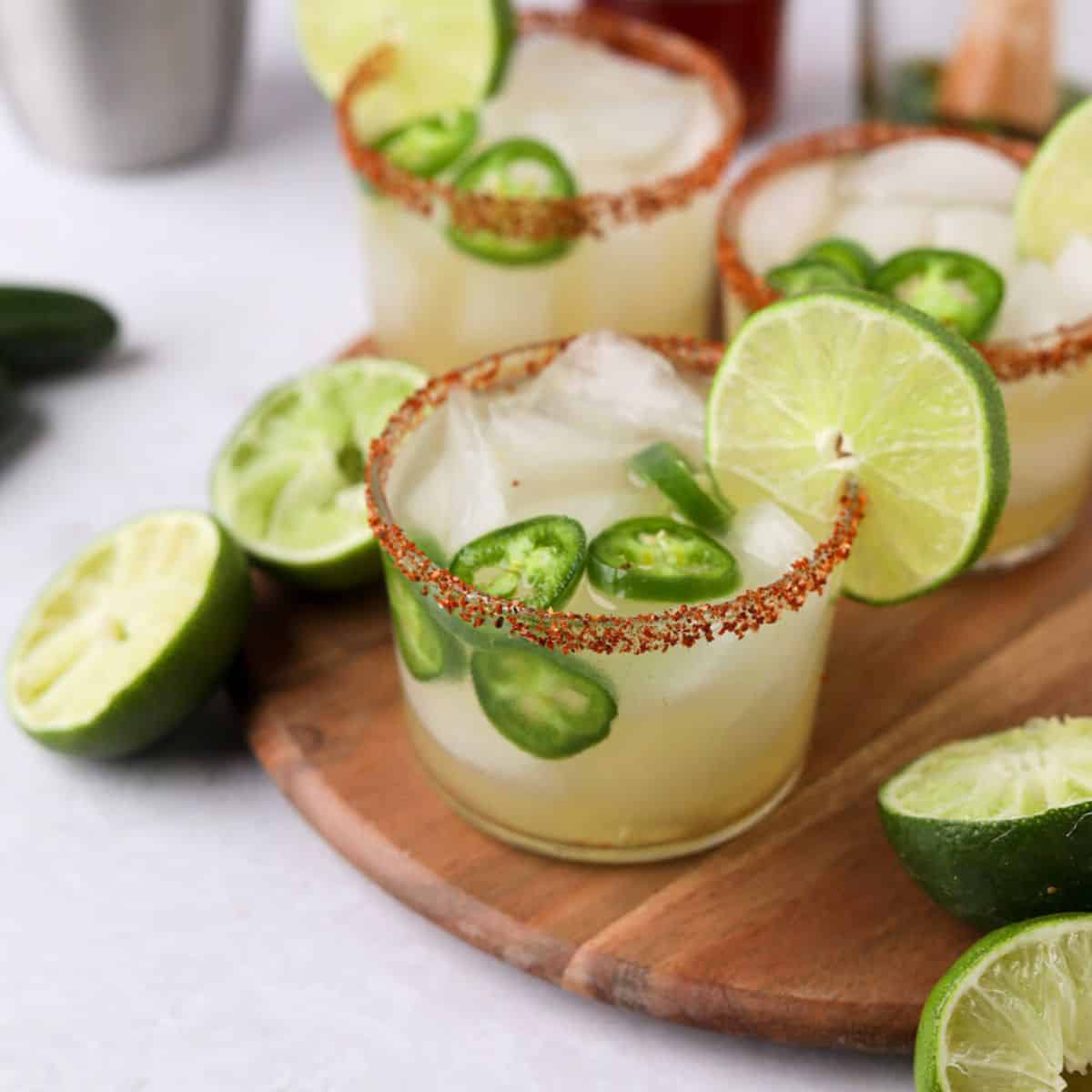 Jalapeno margarita on table with lime wheel.