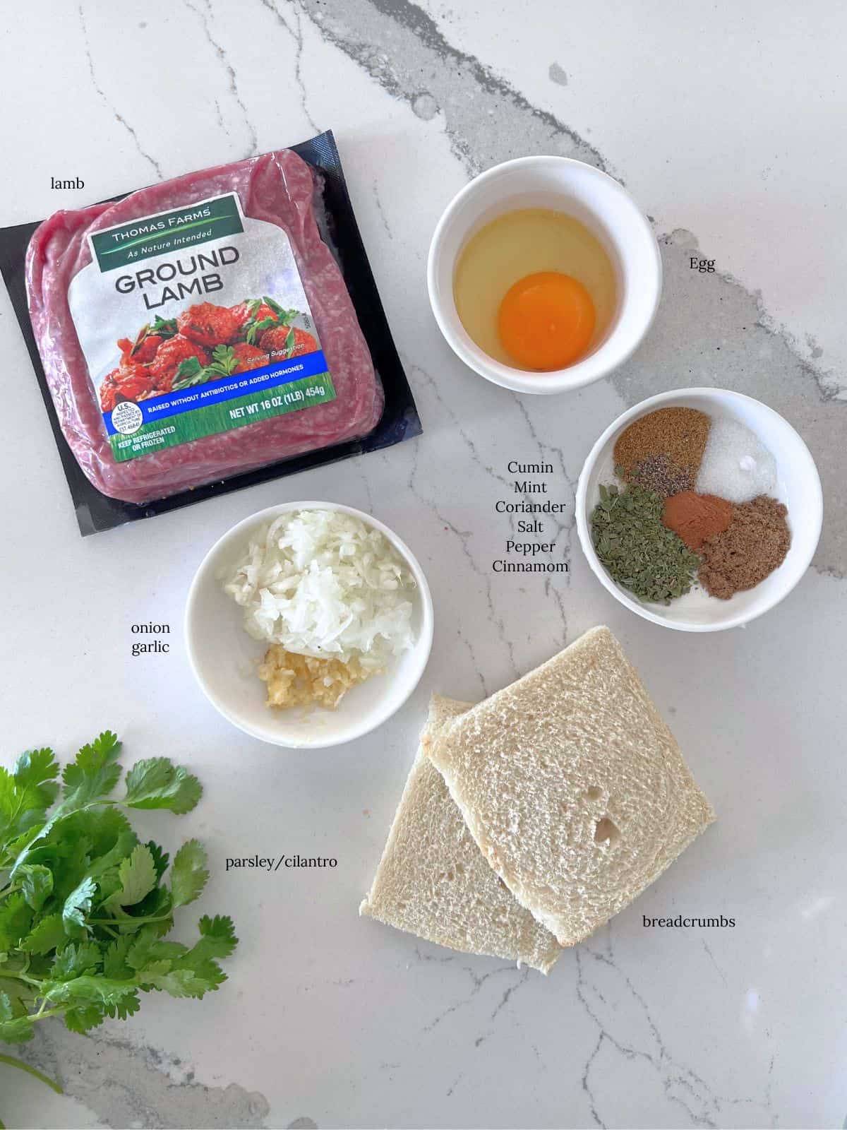 Ingredients to make lamb meatballs on table.