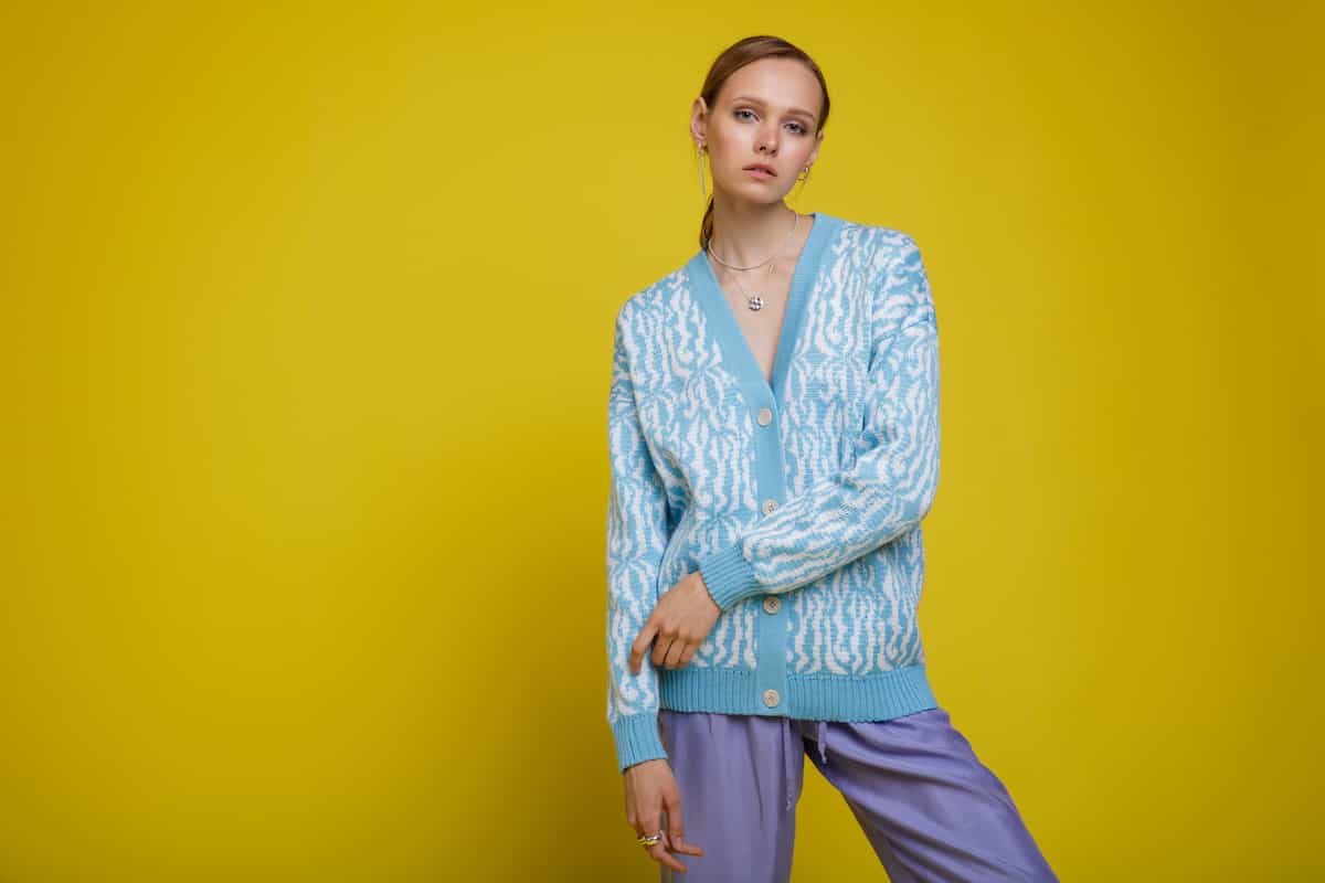 Lady wearing a blue and white cardigan.